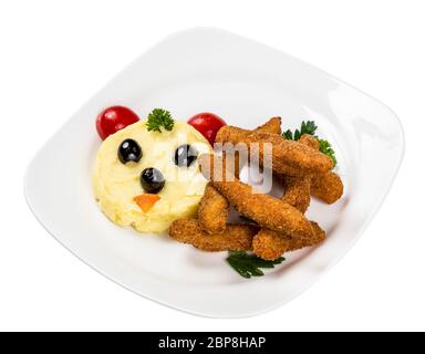 Restourant serving dish for child`s menu - potato puree, sticks with face on white background Stock Photo